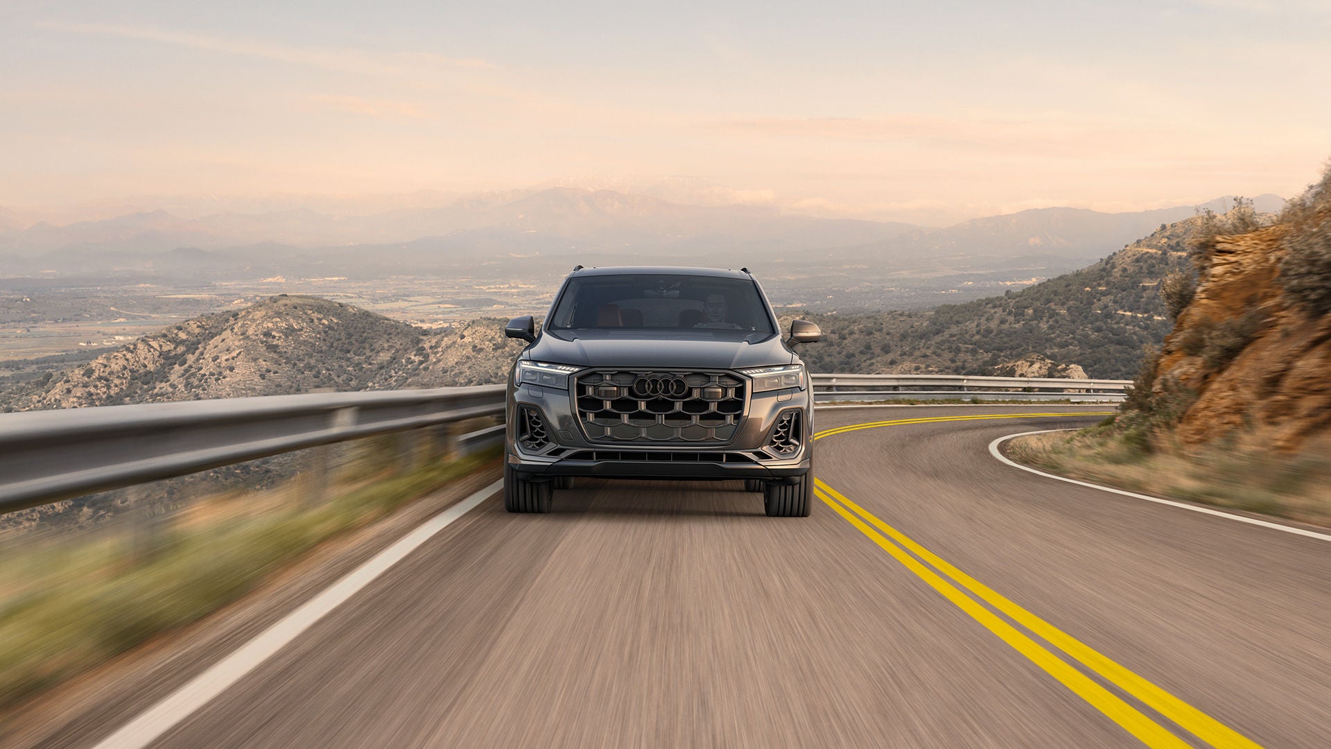 Audi SQ7 Prestige driving up an inclined,  curvy mountain road