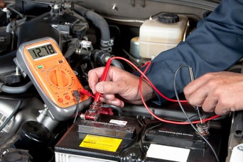 Service technician testing battery