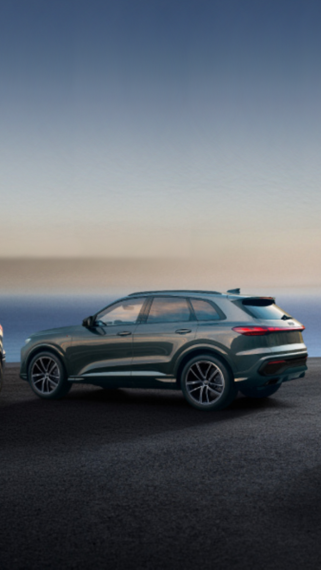 Three Audi vehicles in a lineup parked.