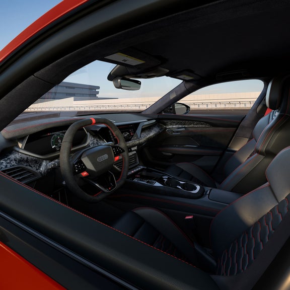 Interior view of the Audi RS e-tron GT, showing the steering wheel and center console.