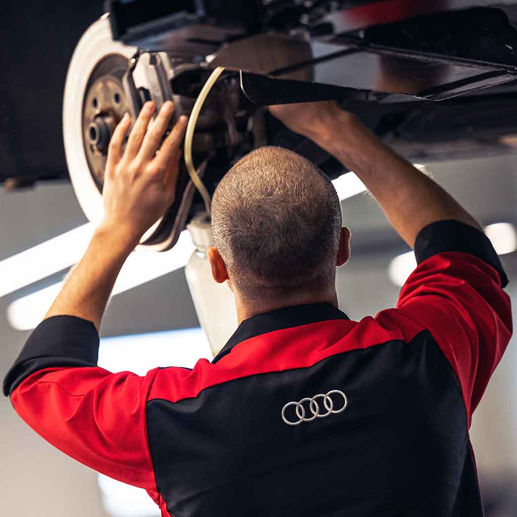 Service advisor inspecting a vehicle.