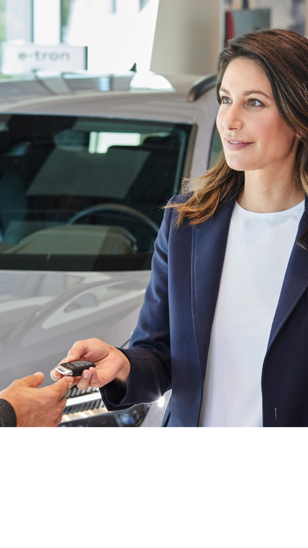 Image of Audi employee greeting a customer. 