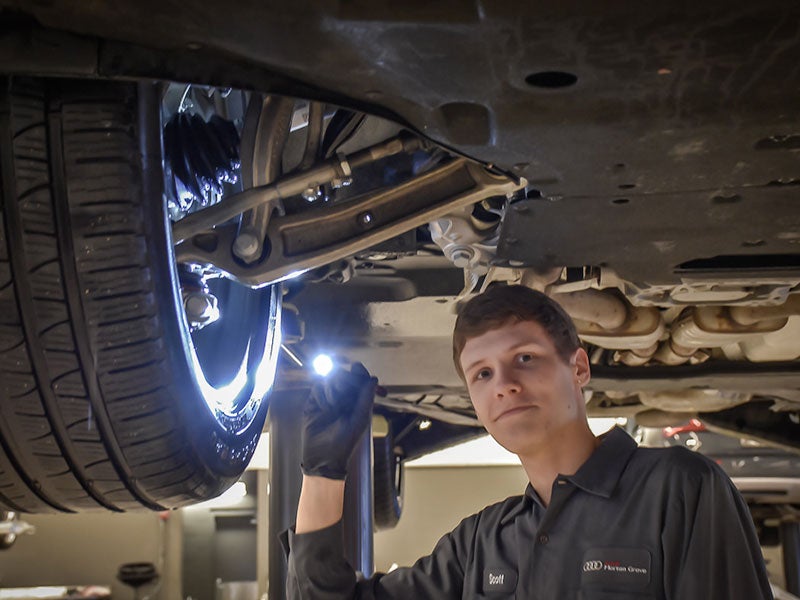 Service technician serving vehicle.