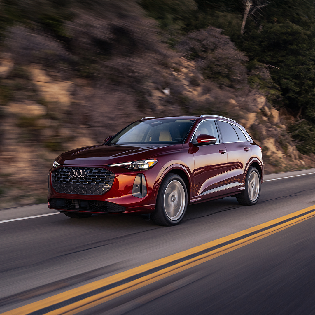 Side profile view of an Audi vehicle accelerating.
