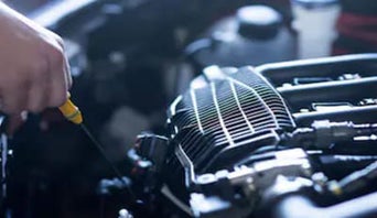 Service technician serving vehicle.