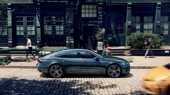 Side view of an Audi A7 parked on a city street.