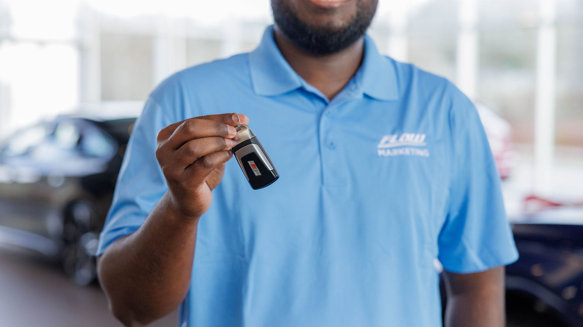 Audi employee holding a car key.