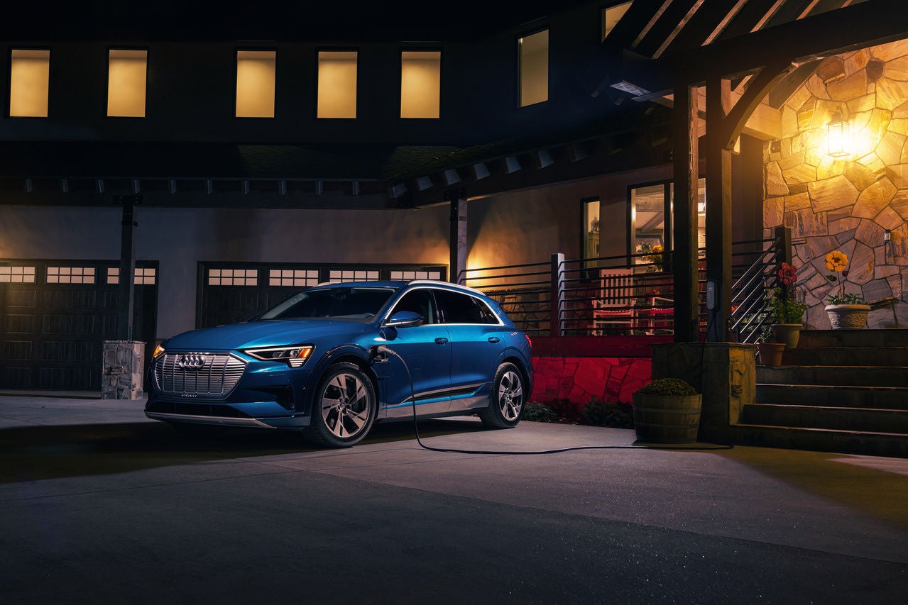 Right side profile view of an Audi e-tron parked.