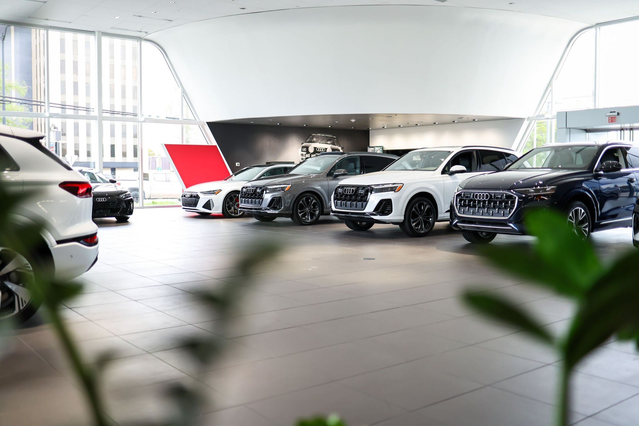 Audi vehicles displayed inside a dealership showroom