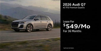 Three quarter view of an Audi Q7 driving.