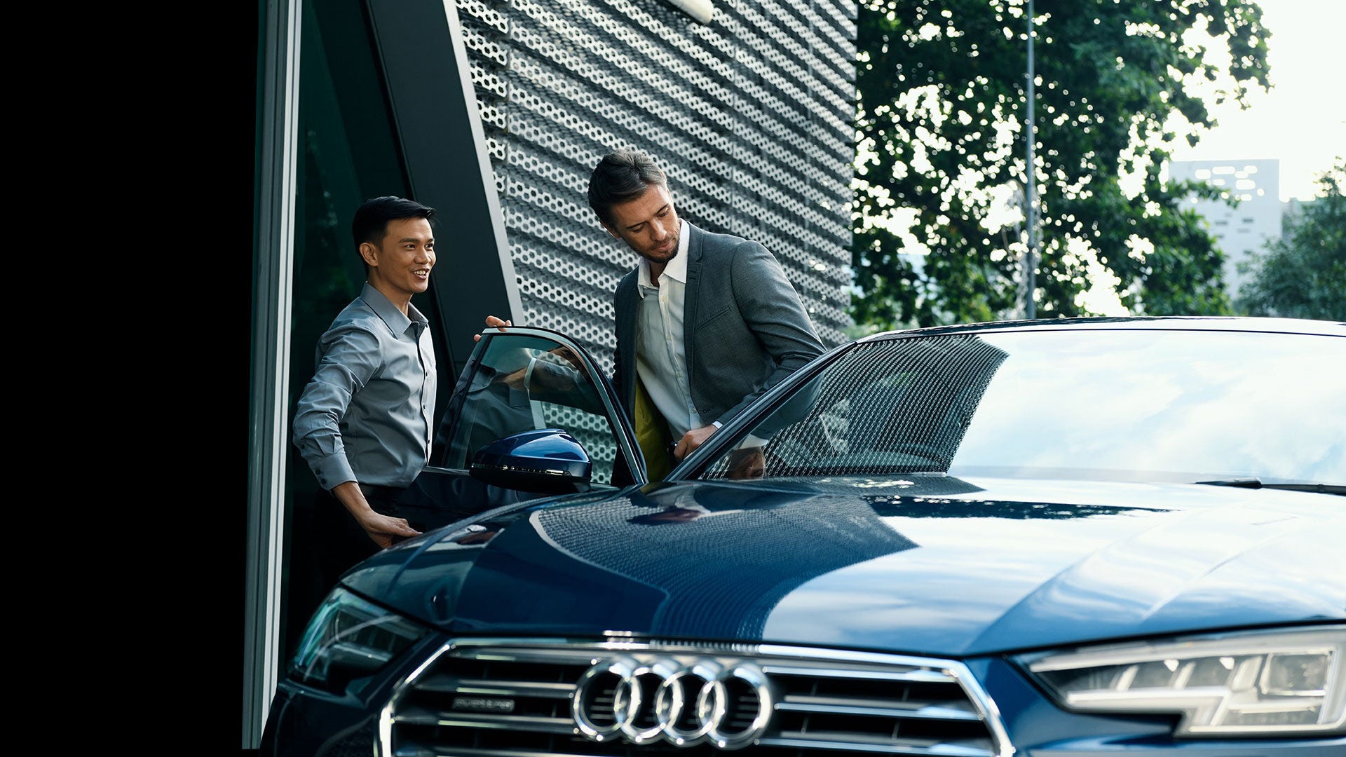 Man getting into an Audi A6.