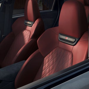 Interior view of the driver's cockpit in the Audi SQ6 e-tron, showing the front sport seats.