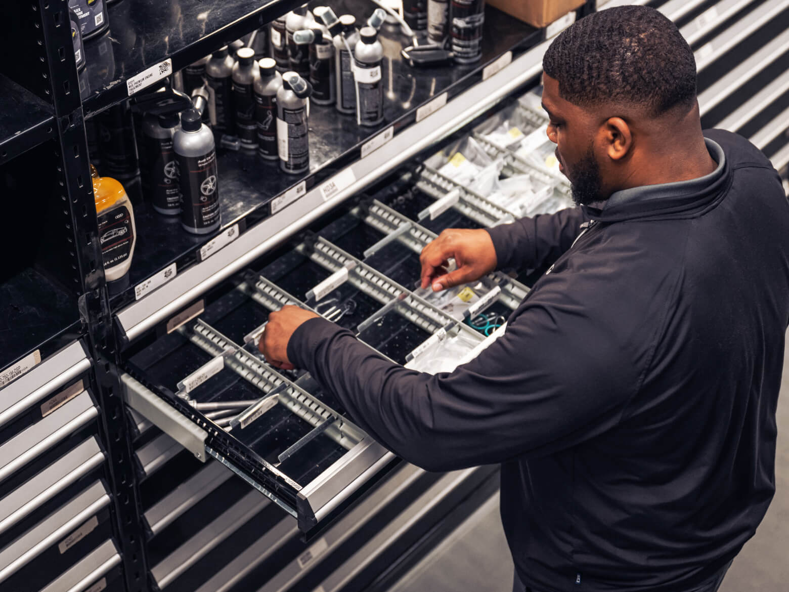 Audi service technician servicing a vehicle.