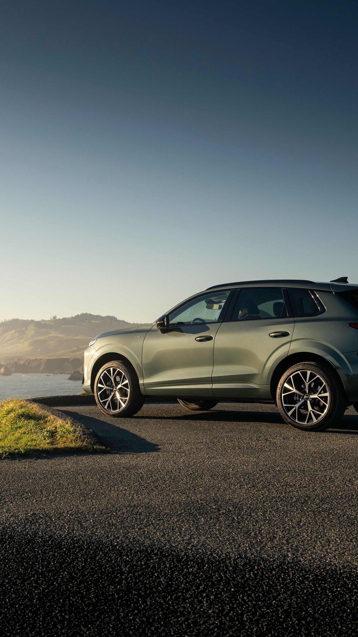 Side profile view of an Audi Q3 parked overlooking water.