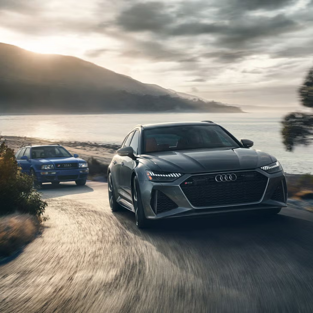 Audi cars on road behind mountain 