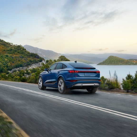 Three-quarter rear view of the Audi SQ6 Sportback e-tron accelerating.