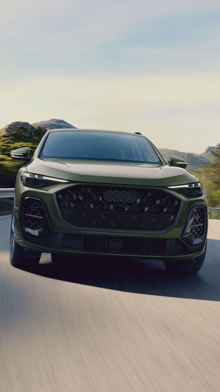 Front view of the Audi Q5 accelerating on a mountainside road.