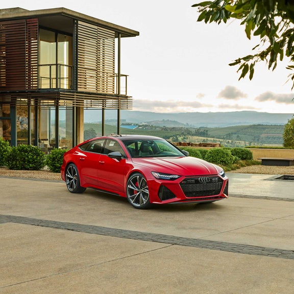 Three-quarter front view of a red Audi RS 7 Sportback parked.