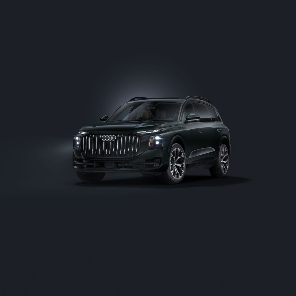 The Q9 SUV, viewed from the front at an angle against a dark background.