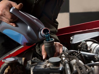 Service technician servicing vehicle.