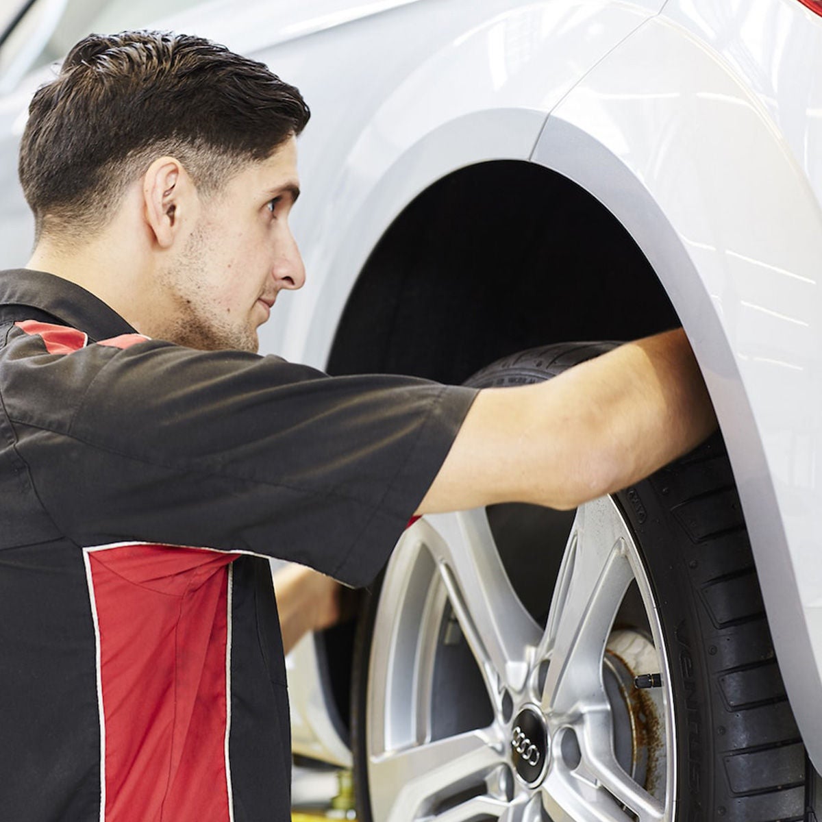 A mechanic installing Audi parts