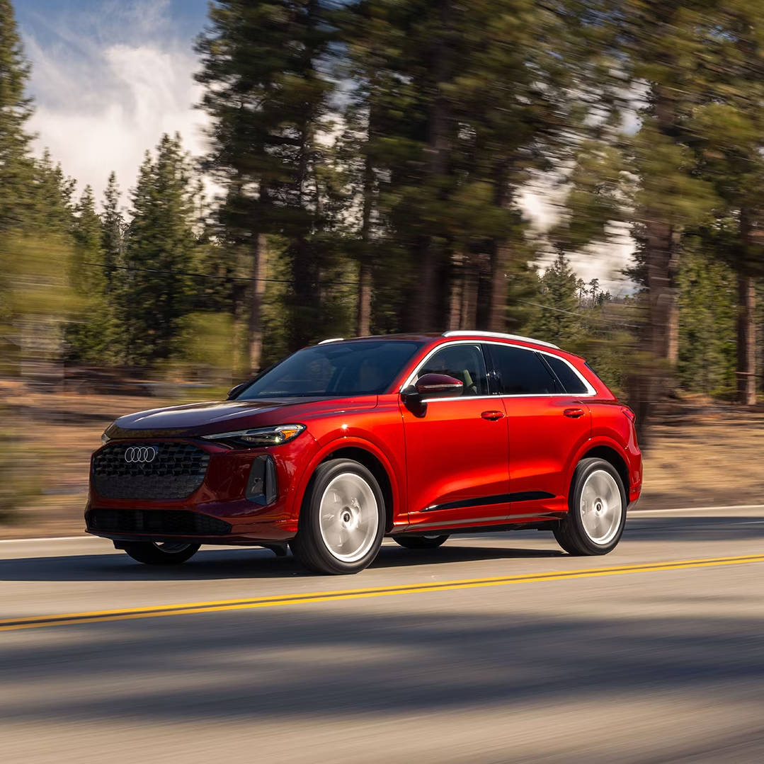Left side profile view of an Audi Q5 accelerating.