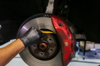 Service technician serving vehicle.