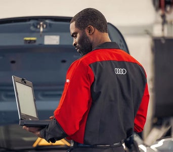 Service technician inspecting a vehicle