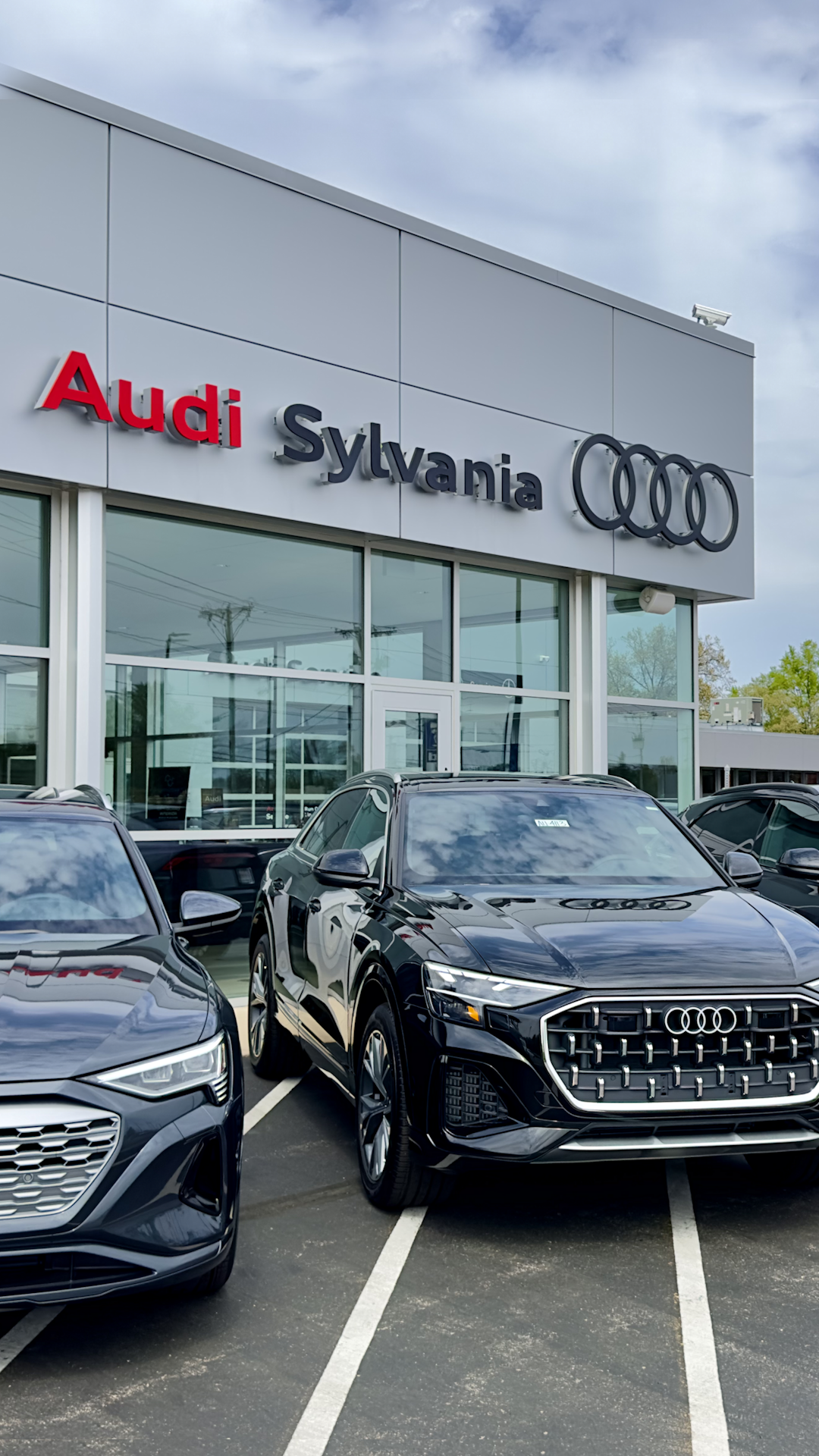 Audi Sale Specialist walking through the showroom with a couple.