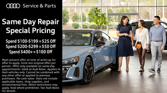 Service technician servicing vehicle with hood open.