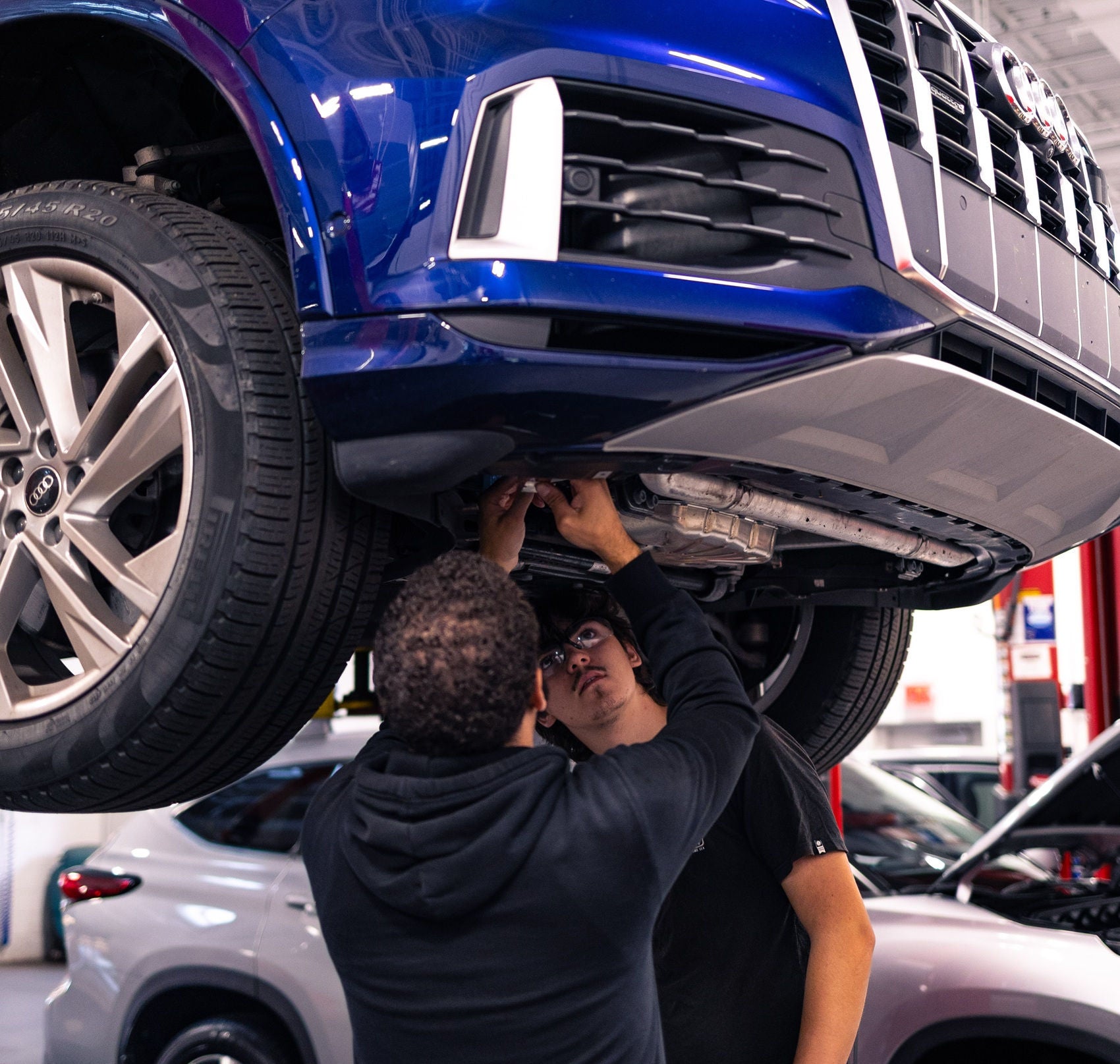 Audi employee handing a set of car keys to a customer.