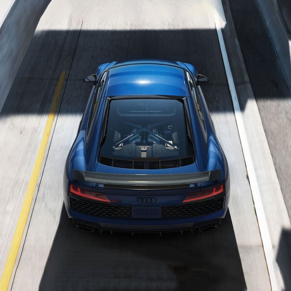 Aerial rear-view of the Audi R8 Coupe on the road.