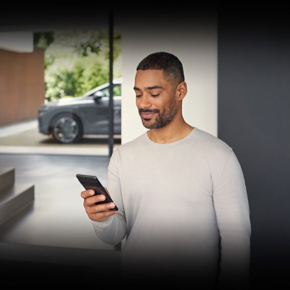 An Audi owner monitoring his payments and subscriptions using the myAudi app on his smartphone.