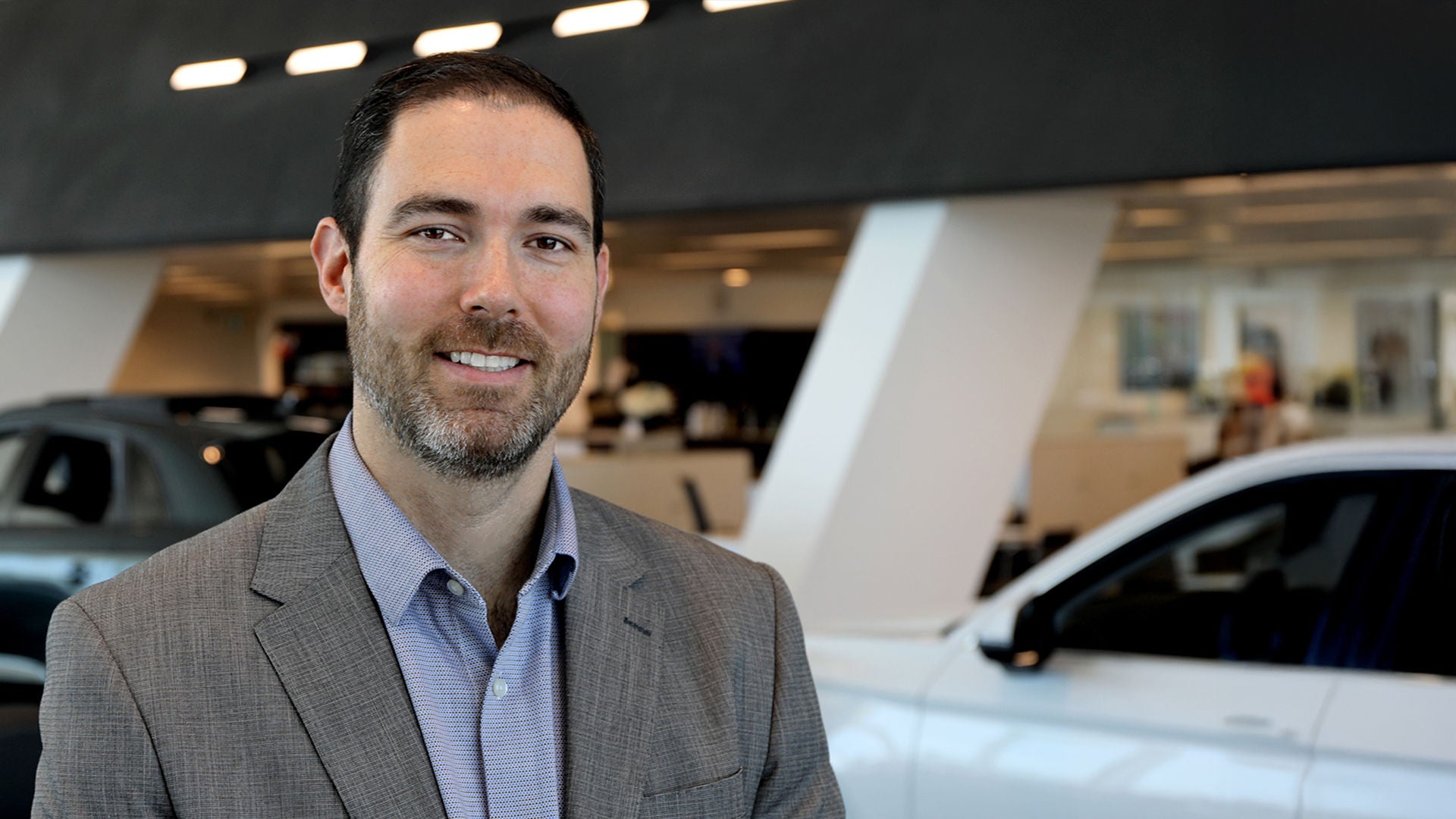 A photo of Michael Crosby, the Dealer Principal in the Audi Showroom