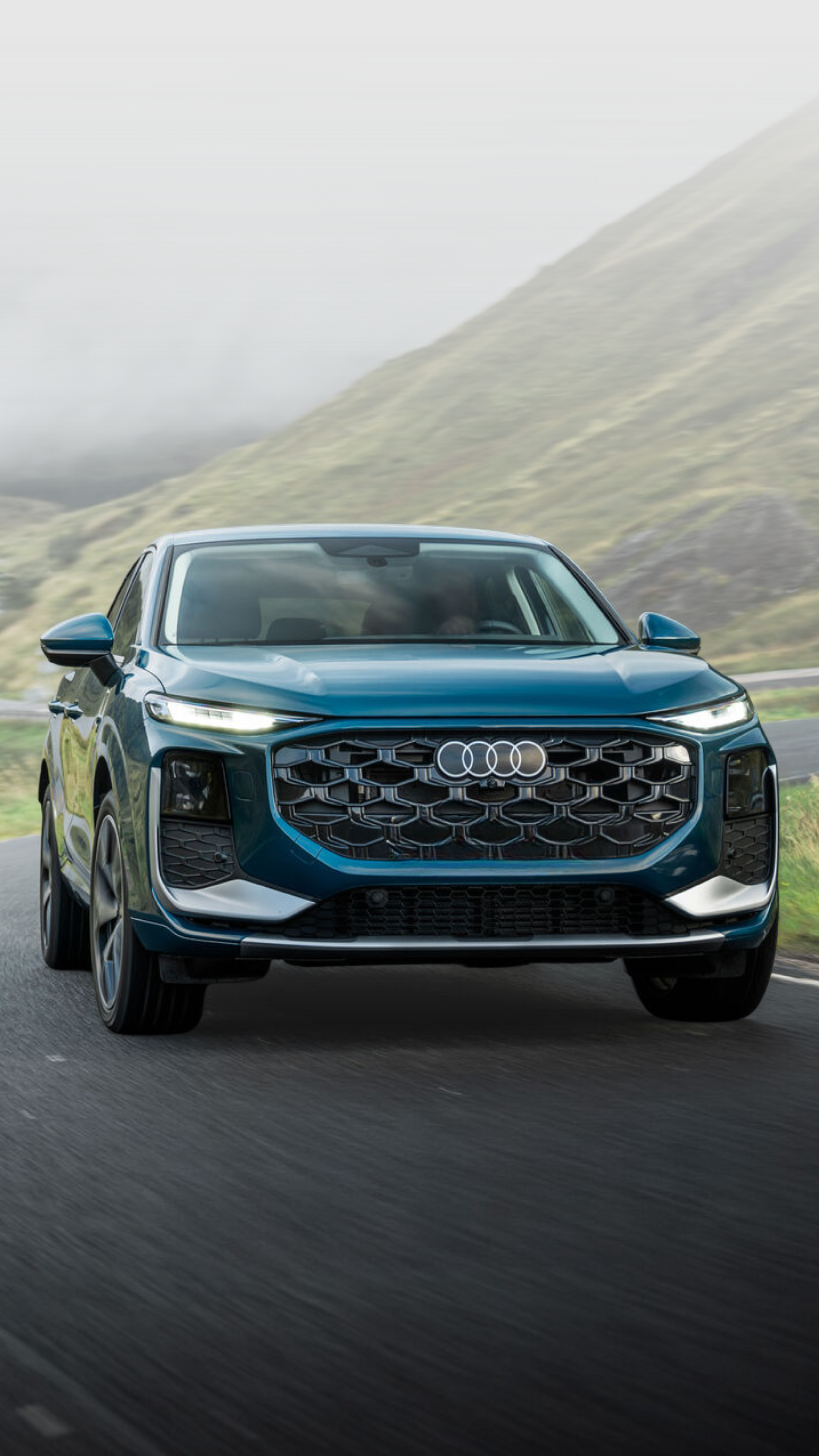 Audi 2025 Audi Q6 e-tron left profile driving.