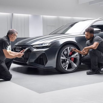 Service technicians serving vehicle.