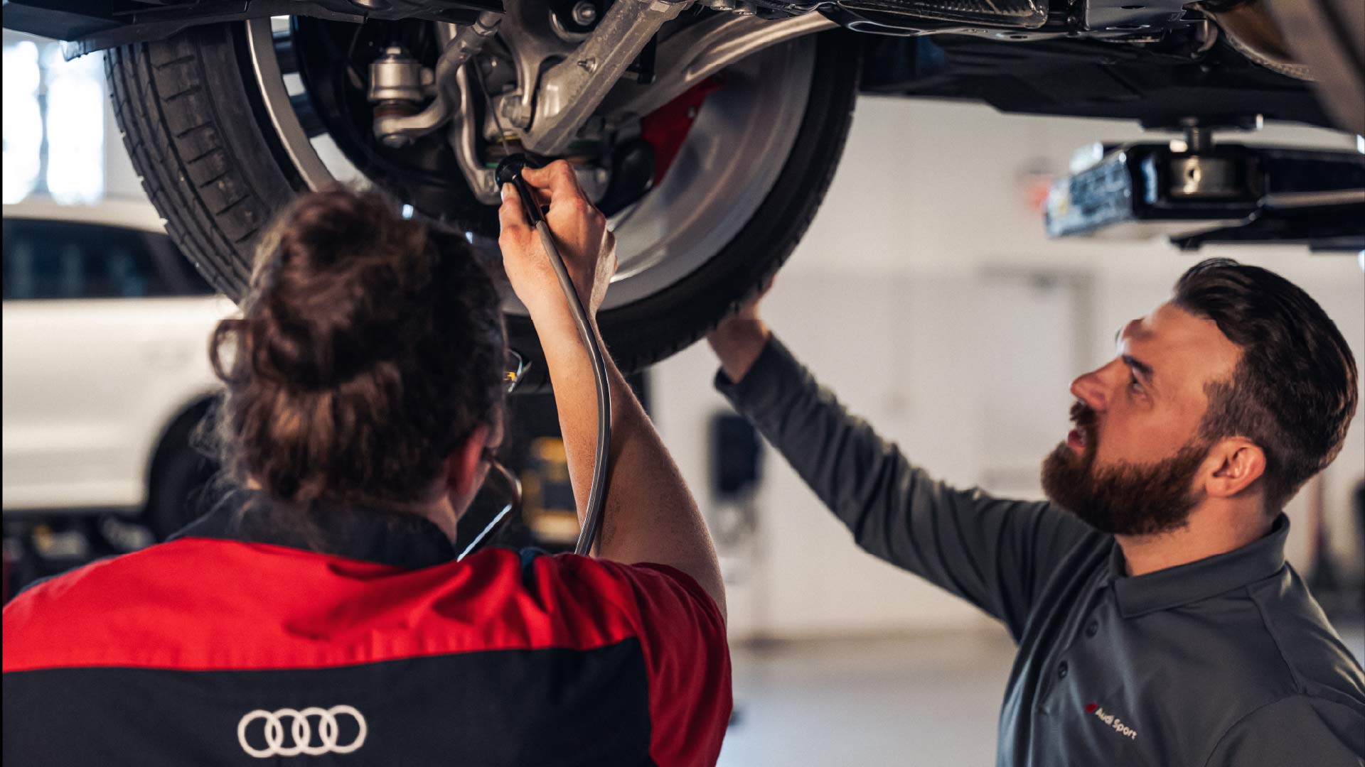 Audi service technician servicing a vehicle.