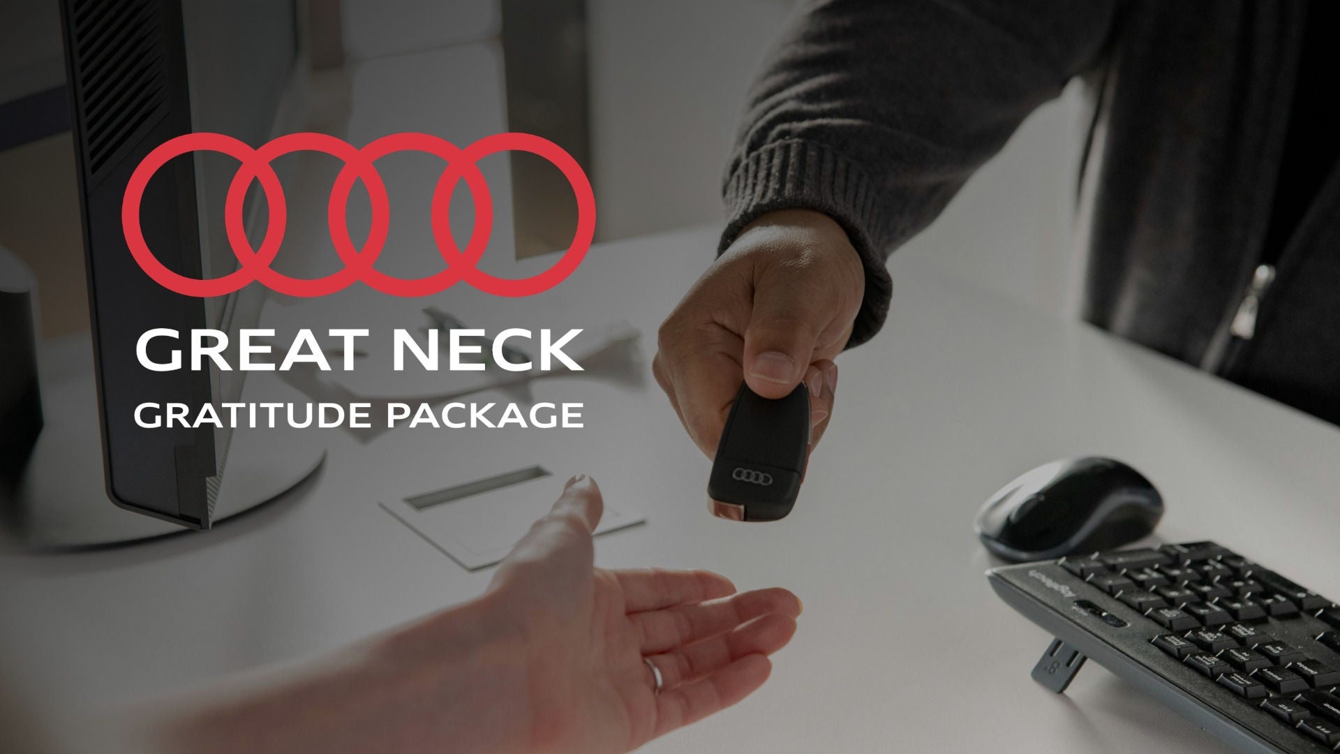 Salesperson handing over Audi key to customer.
