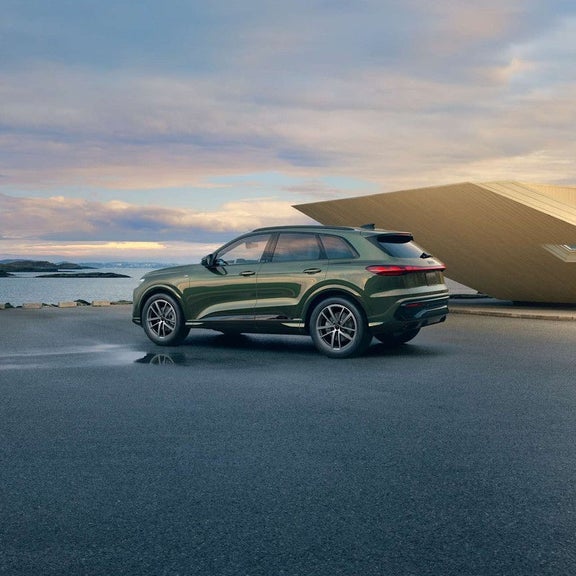 2026 Audi Q5 full side profile at dusk showing its sloping roofline, shoulder line, and wheels at Audi Sewickley near Pittsburgh PA