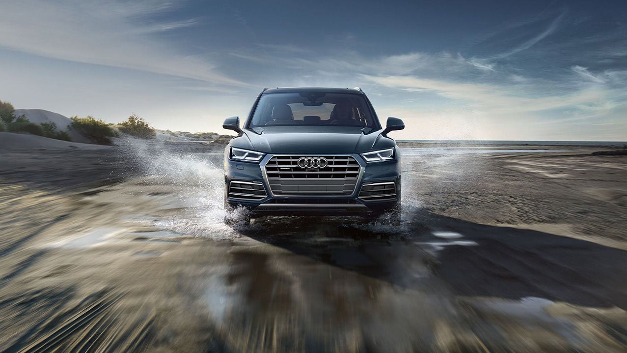 View of the quattro® all-wheel drive driving through wet weather conditions.