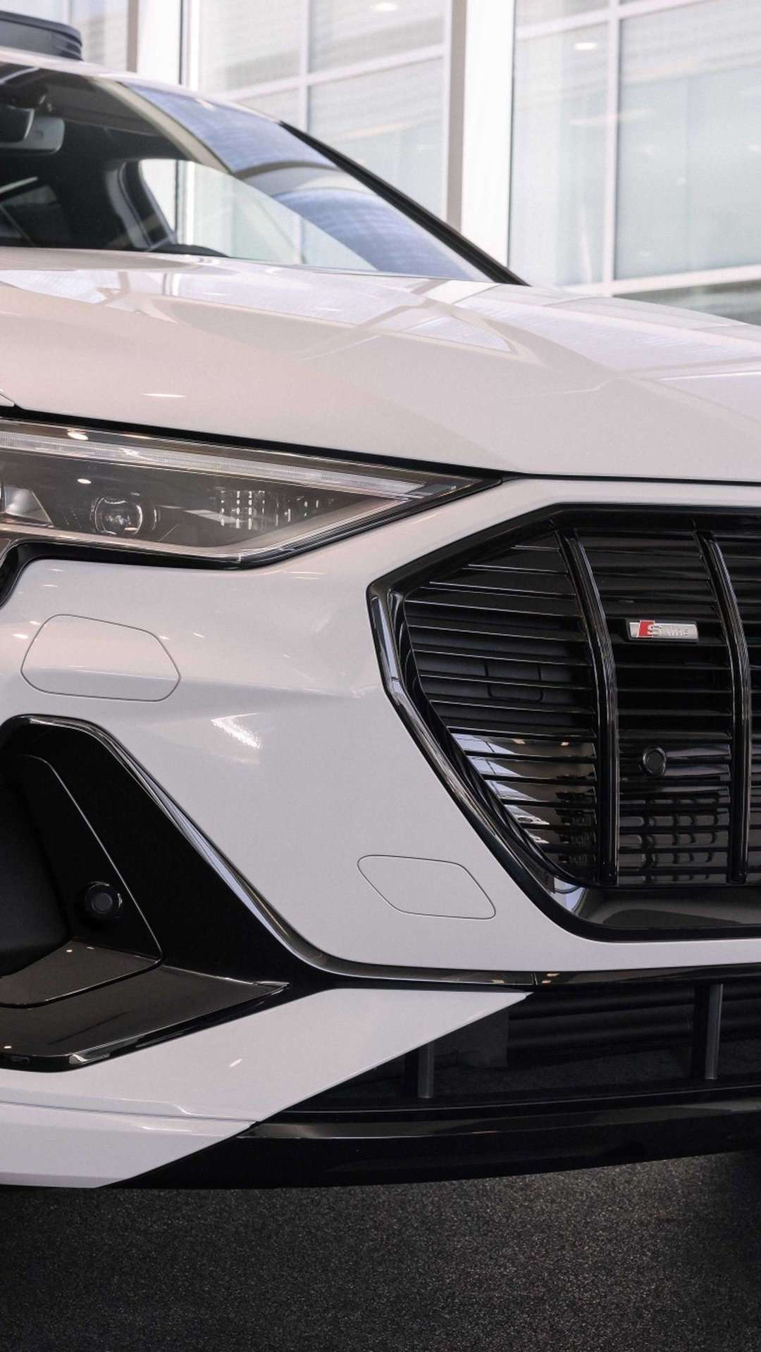 Three quarter view of an Audi E-tron parked.