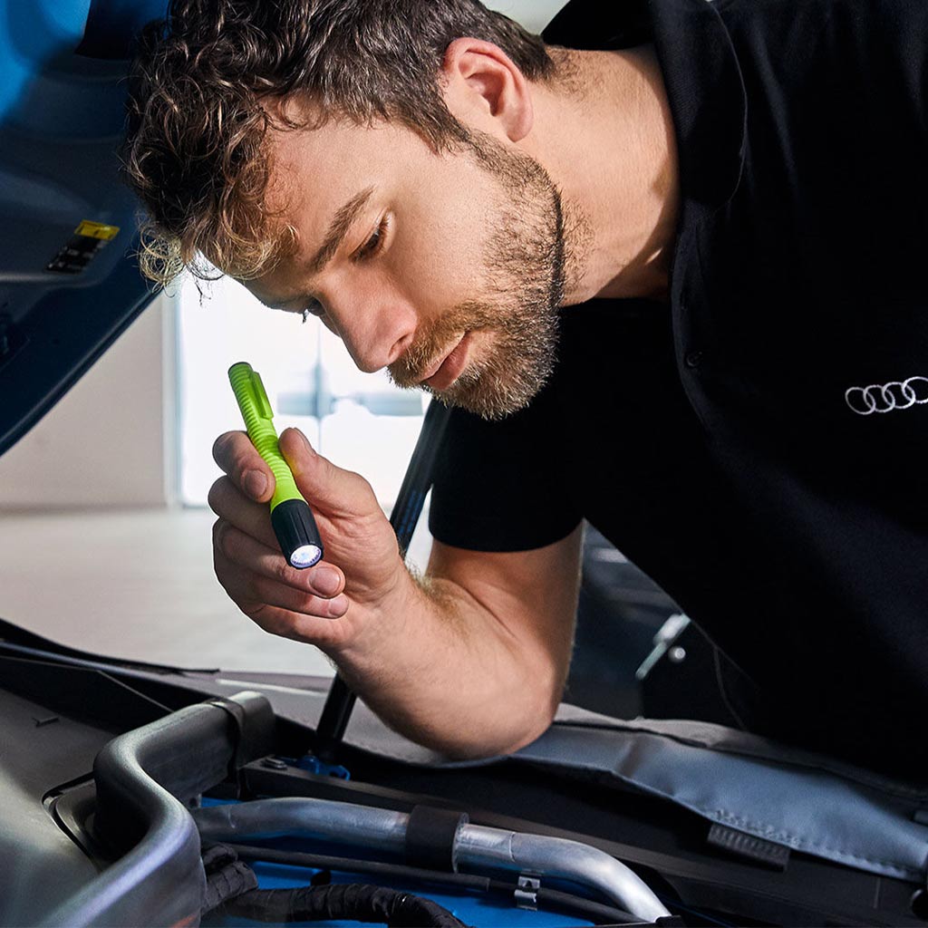 Service technician servicing vehicle.