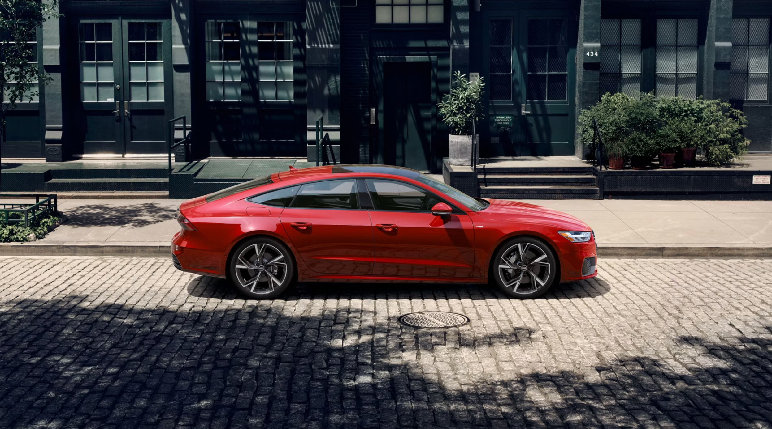 2025 Audi A7 Side-Profile Parked in Grenadine Red Metallic near Lafayette, LA