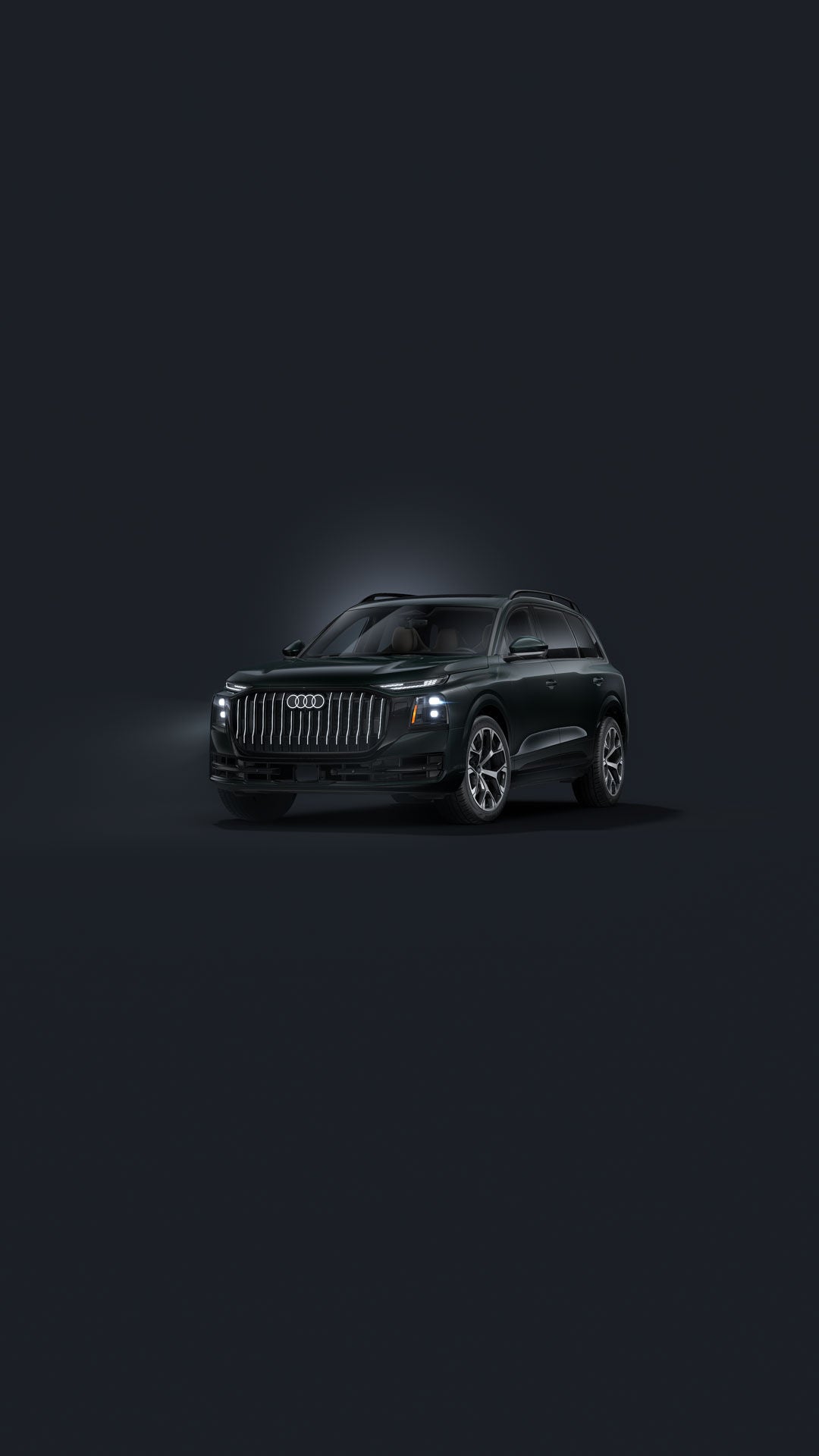 The Audi Q9 SUV, viewed from the front at an angle against a dark background.