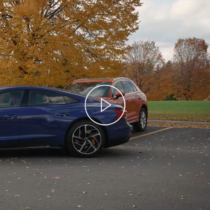 An Audi vehicle backing into a parking space. 