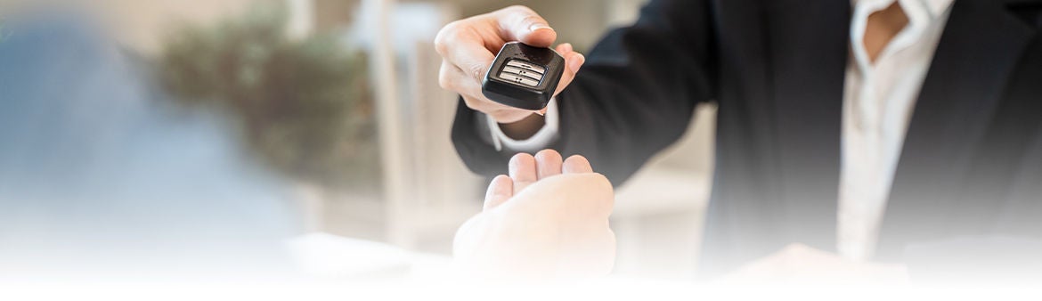 Audi representative handing over the car key.