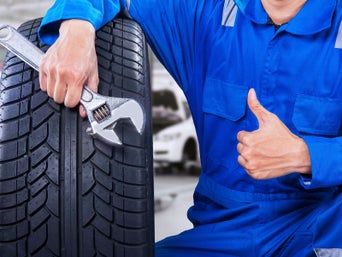 Service technician with a tire.