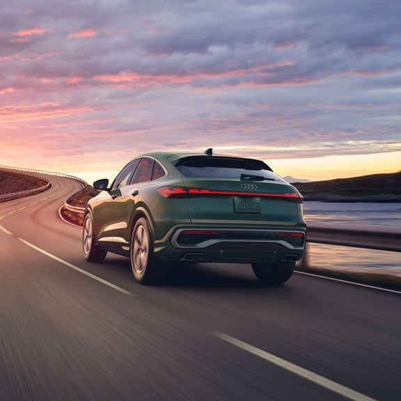 Three-quarter rear view of the Audi Q5 Sportback accelerating.