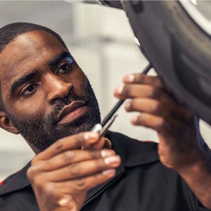 technician measuring tire tread