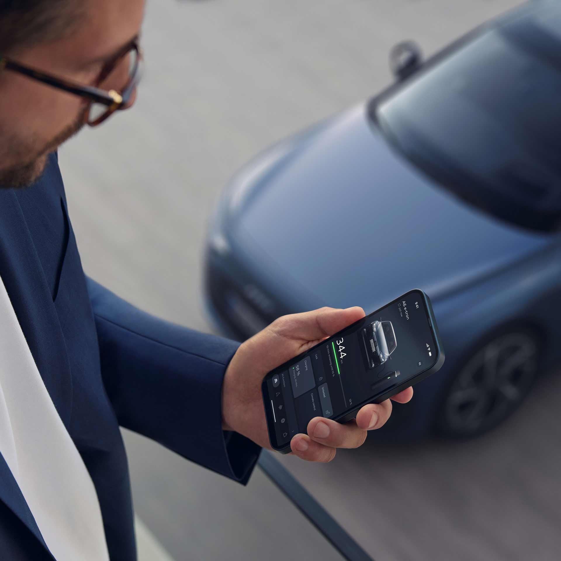 A man browsing his myAudi dashboard on a laptop.